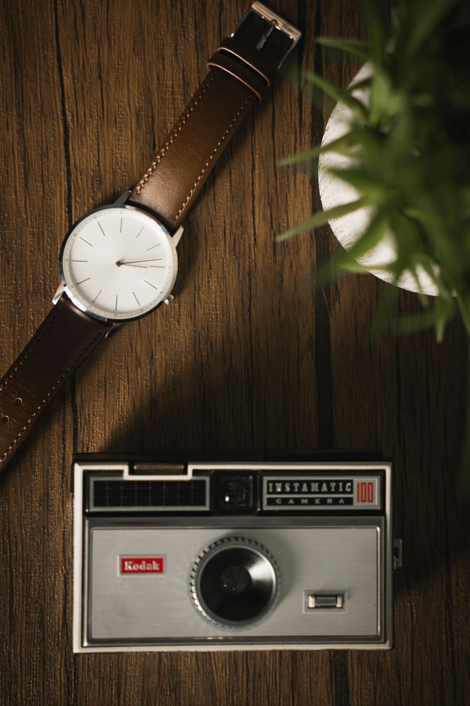 A worn vintage wristwatch with a brown leather strap.